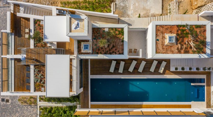 Photo of White Walls & Blue Skies