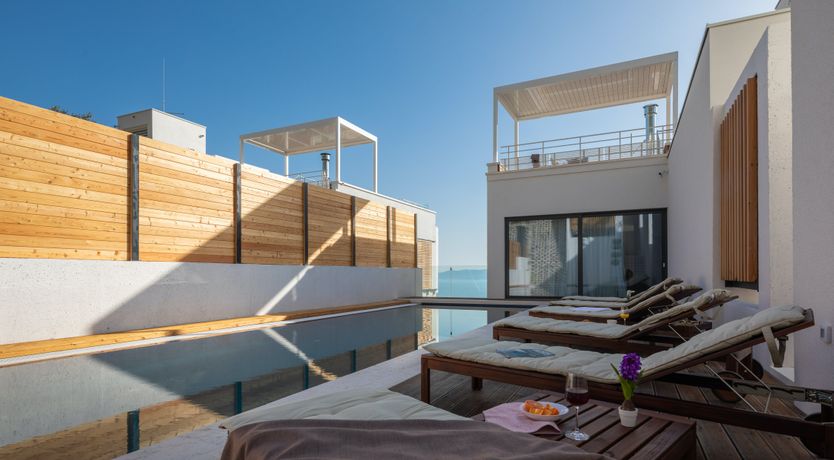 Photo of White Walls & Blue Skies