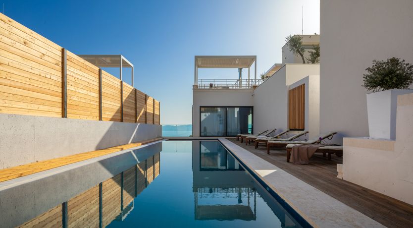 Photo of White Walls & Blue Skies