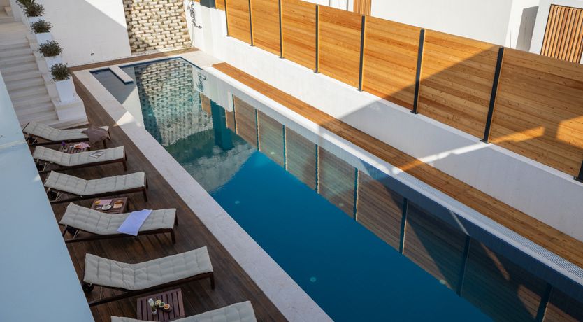 Photo of White Walls & Blue Skies