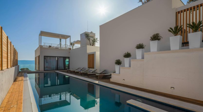 Photo of White Walls & Blue Skies